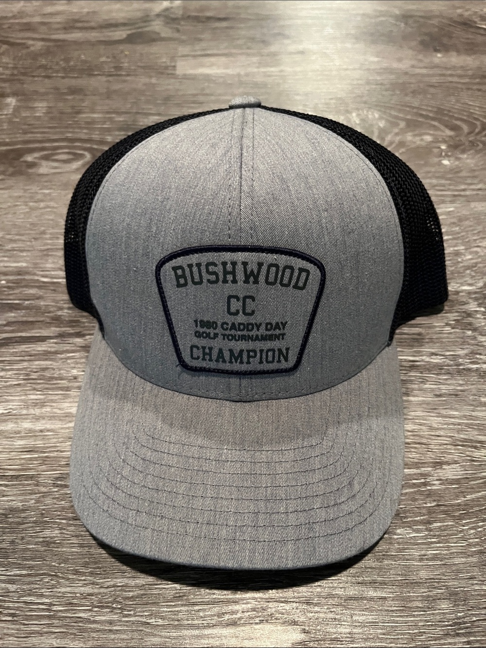 Travis Mathew Gray and Black Bushwood Champion Trucker Hat